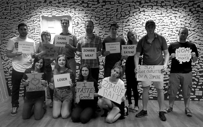 We are the losers of the room escape game as we did not beat the zombie and we are holding our loser cards on display