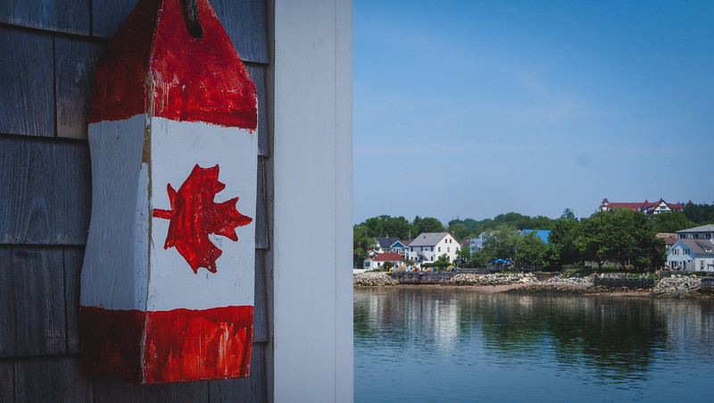 We visited St. Andrews on a day trip and walked along the marina and spotted a Canadian flag buoy hanging on the outside of building