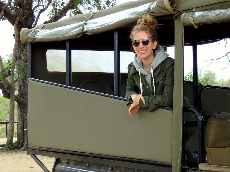 What to wear on safari with That Backpacker Audrey Bergner wearing comfortable clothes, sunglasses and a big smile