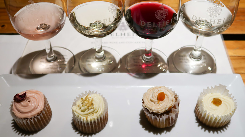 Wine and cupcake tasting at Delheim in Stellenbosch, South Africa trying red, white and rose with different cupcakes