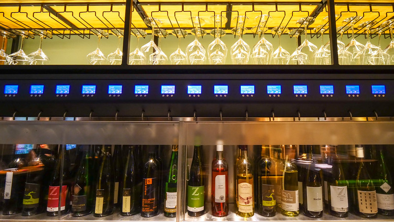 Wine bar at Freylich Zahn Weinhotel in Freyburg, Germany with a full display of wines on offer and glasses above them