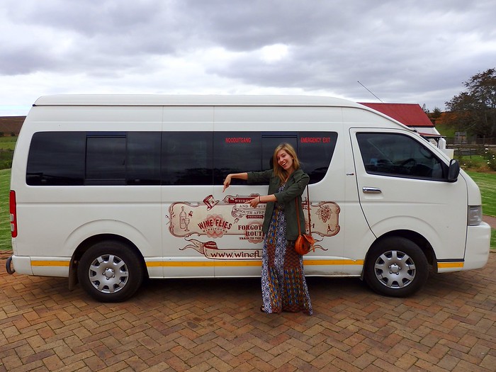 Wine Flies Wine Tour in Stellenbosch, South Africa with That Backpacker Audrey Bergner standing outside of the van 