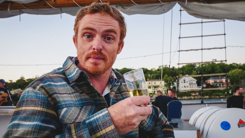 Wine tasting aboard Tall Ship Silva on a 130-foot schooner in Halifax, Nova Scotia with Nomadic Samuel happy to be taking delightful sips 