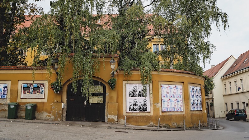 Yellow building in Zagreb, Croatia with posters and artwork on display 