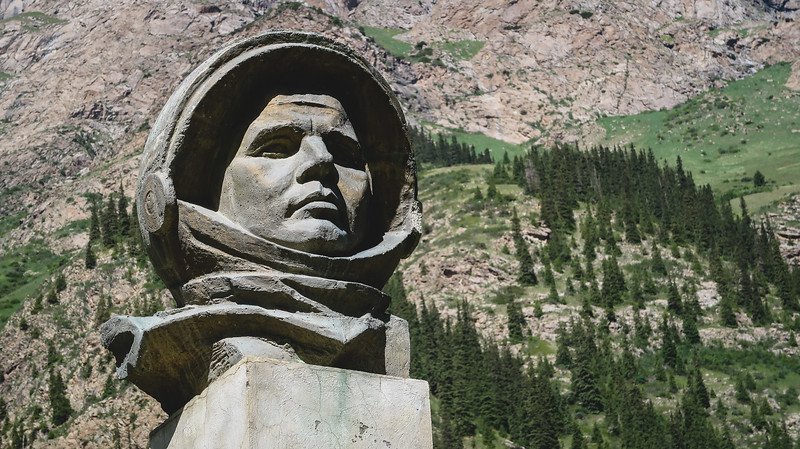Yuri Gagarin Bust at the Barskoon Waterfalls is a landmark with epic scenery in the background in Kyrgyzstan 